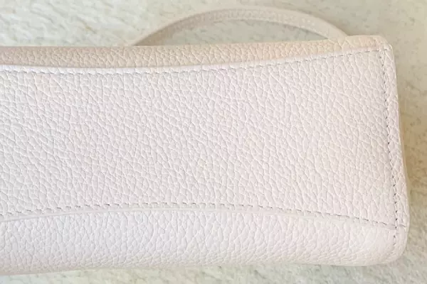 clean underside of white leather bag