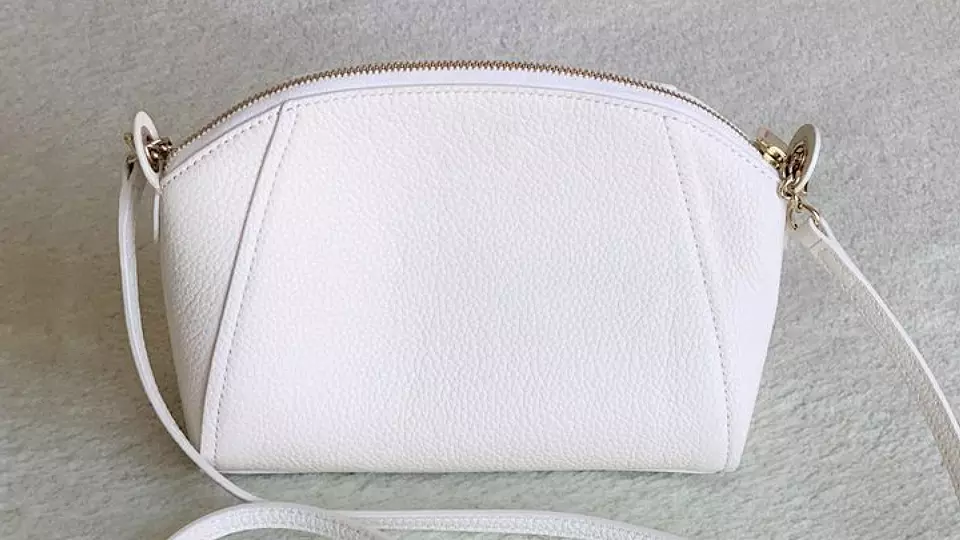 cleaning a white leather bag